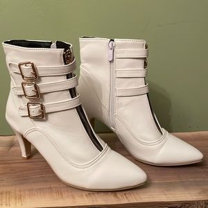 Winter white gold buckled faux leather boots.